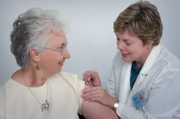 Caregiver gently assisting an elderly senior at home